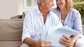getty images mature couple laughing looking at papers x beb.jpeg