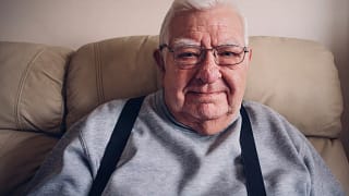getty slightly grinning senior in suspenders.jpg