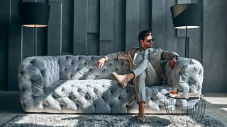 man in suit on fancy couch.width .jpg