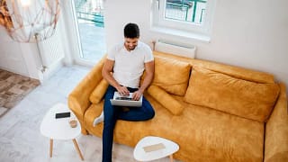 man on laptop on couch.width .jpg