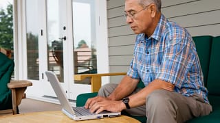 older man laptop outdoors gettyimages .jpg