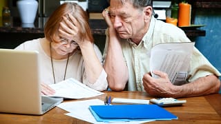 senior couple worried looking at bills finances debt.jpg