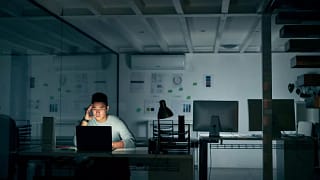 stressed man on computer in dark office qNpmh.width .jpg