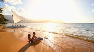 two people sitting on beach VNkuAk.width .jpg
