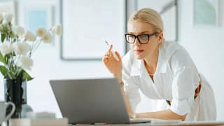 woman s leaning over a laptop gettyimages .jpg