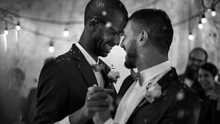 Smiling men dancing at their wedding fexRG.width .jpg