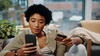 Young woman pays for online purchase with cre.width uHthJ.jpg