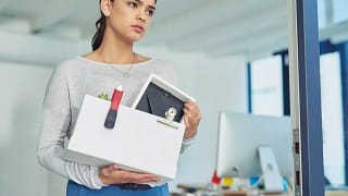 fired woman leaving office with box of things.width .jpg