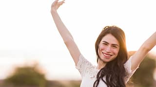 getty happy arms outstretched outdoors smiling.jpg
