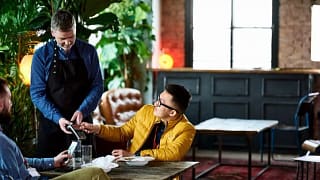 man paying in restaurant with credit card BH.width .jpg