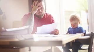 man with baby and papers at dining table.width .jpg