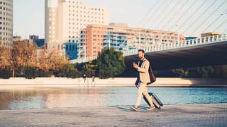 man with suitcase walking outside.width .jpg
