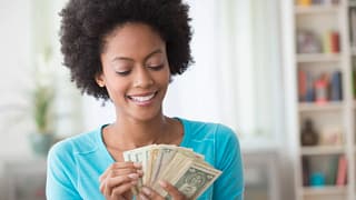 smiling person counting money.jpg