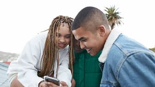 three people looking at phone PkLfKJi.width .jpg