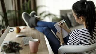 woman at desk writing in notebook JzYthUs.width .jpg