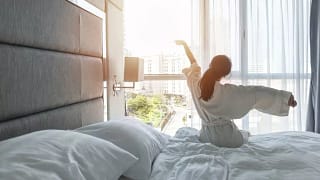 woman waking up in hotel.width .jpg
