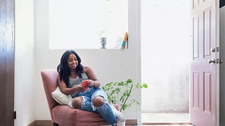 young adult holding phone in chair ZcjAQ.width .jpg