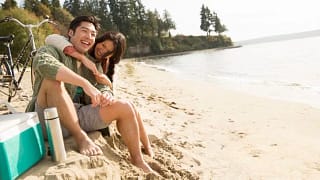 couple smiling on beach wgjJzZ.width .jpg