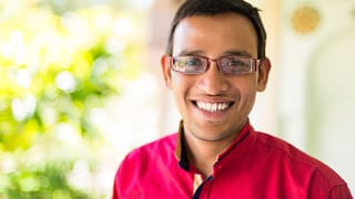 getty happy smiling young person in pink shirt.jpg