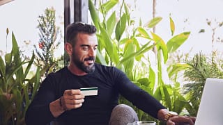 man in cafe with credit card and laptop.width .jpg