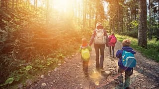 mom and kids hiking in forest AuytLy.width .jpg