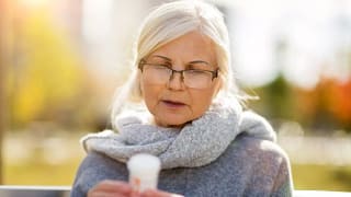 older woman reading pill bottle.width .jpg