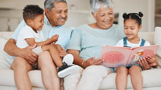 smiling couple reading books to children.jpg