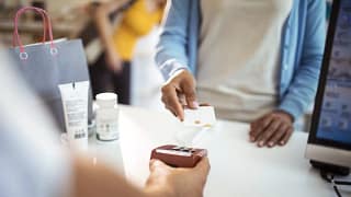 woman paying with credit card at pharmacy SRR.width .jpg
