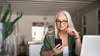 woman with phone and laptop at home.width loP.jpg