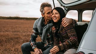 Middle age couple smiling in car CgSLrS.width .jpg