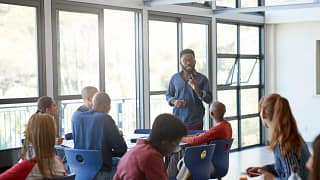 Young adult male speaking to students in clas.width eZlvXFB.jpg