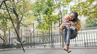 Young mother with infant at city park. AbbKi.width .jpg