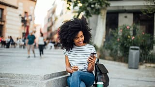 Young woman makes an online purchase while si.width equBkZ.jpg