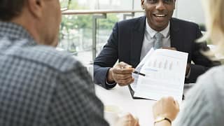 mature couple talking to financial advisor PO.width KFkW.jpg