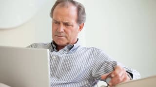 older man laptop serious expression looks unhappy gettyimages .jpg