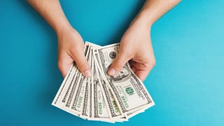 person holding hundred dollar bills copy .jpg