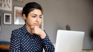 serious person with hand on chin looking at laptop.jpg