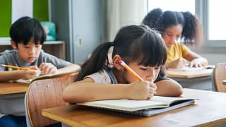 three young kids in classroom BgNhPc.width .jpg
