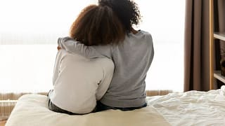 Mother daughter sitting on bed RVrqggy.width .jpg