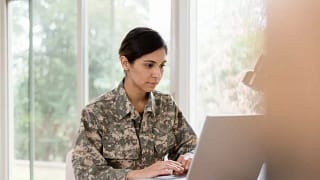WomanVetLookingAtLaptop.width .jpg