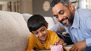 family child saving piggy bank financial lessons save money x bdf.jpg