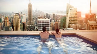 getty images rooftop pool new york skyline vacation couple honeymoom x bdf.jpeg