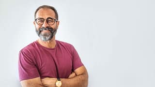 getty smiling person in pink tshirt beard.jpg