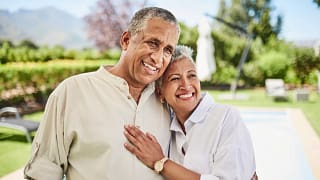 gettyimages older couple man and woman smiling pool millionaire wealthy.jpeg