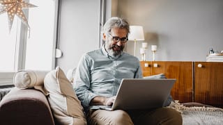 older man smiling laptop gettyimages .jpg