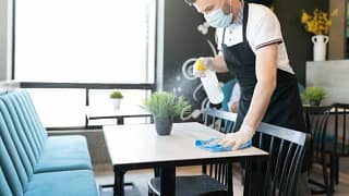waiter in mask cleaning restaurant table CcOi.width .jpg