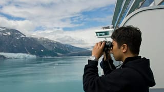 Person using binoculars on cruise ship GdSIfW.width .jpg
