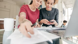 couple looking at documents and smartphone.jpg