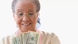 getty happy person with fanned out cash money.jpg
