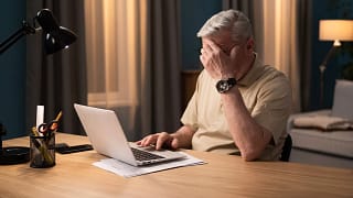older man laptop covering face gettyimages .jpg